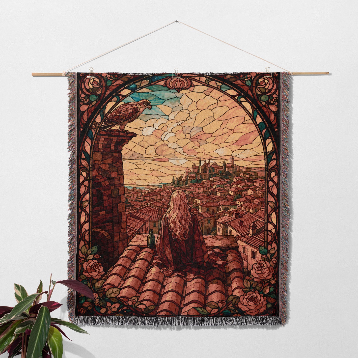 a large tapestry hanging on a wall, depicting a cityscape with a person sitting on a rooftop.