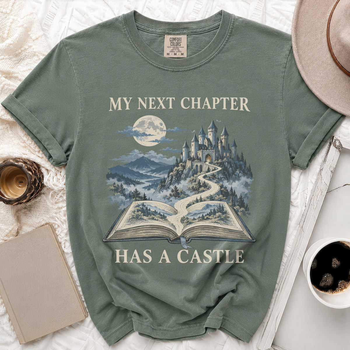 Green t-shirt with "My Next Chapter Has A Castle" text and castle graphic.