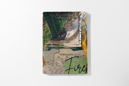 Folded blanket with a fantasy map, mountains, and flames design.
