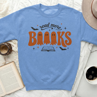 Light blue sweatshirt with "read more Books" ghosts and book design.