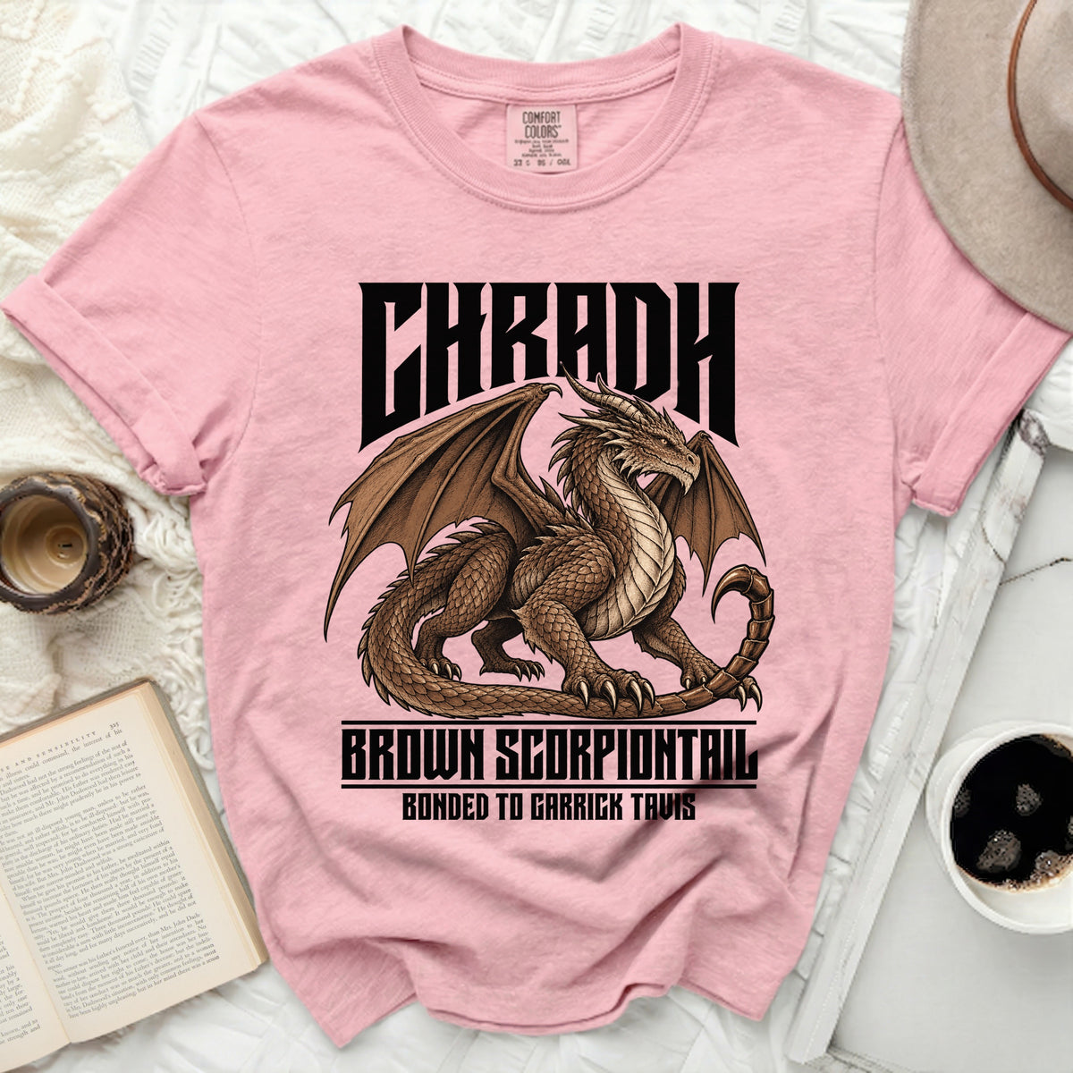 Pink t-shirt with dragon graphic and text CHRADH BROWN SCORPIONTAIL BONDED TO GARRICK TAVIS.