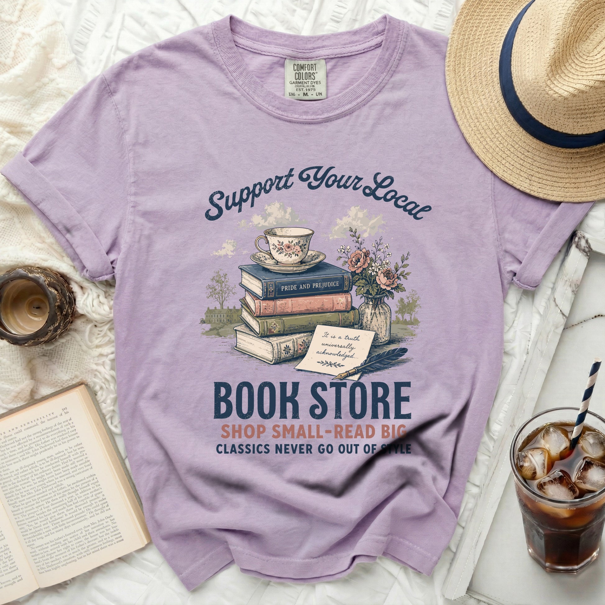 Purple t-shirt with "Support Your Local Book Store" graphic and books.