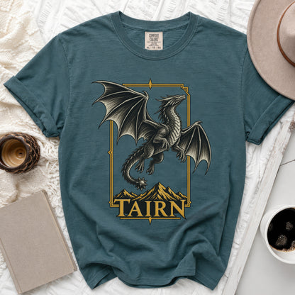 Teal t-shirt with a gold-framed dragon and mountains graphic and "TAIRN" text.
