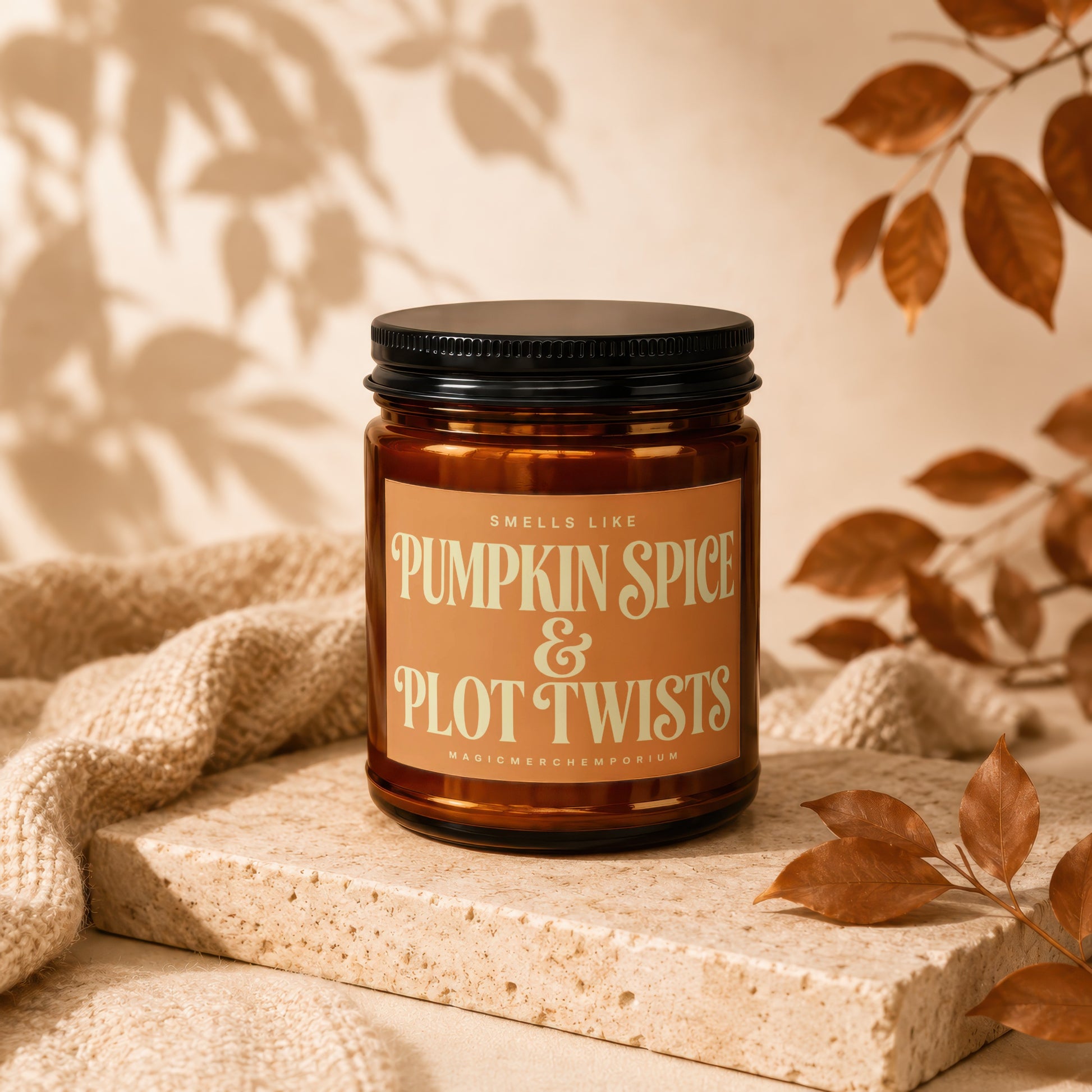 Candle labeled "Pumpkin Spice & Plot Twists" with a black lid and amber jar.