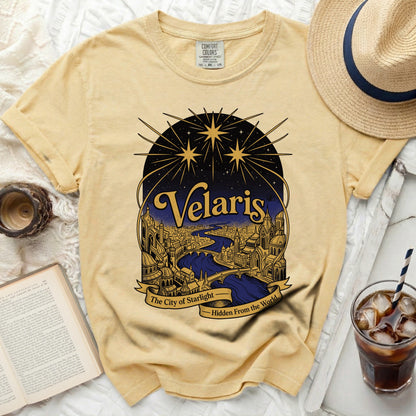 Yellow t-shirt with "Velaris The City of Starlight Hidden From the World" graphic.