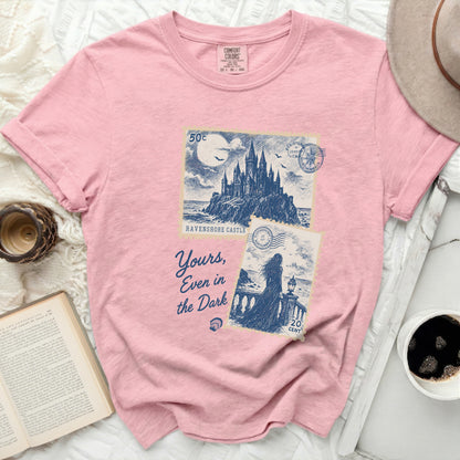 Pink t-shirt with "Ravenshore Castle" and "Yours, Even in the Dark" graphic.