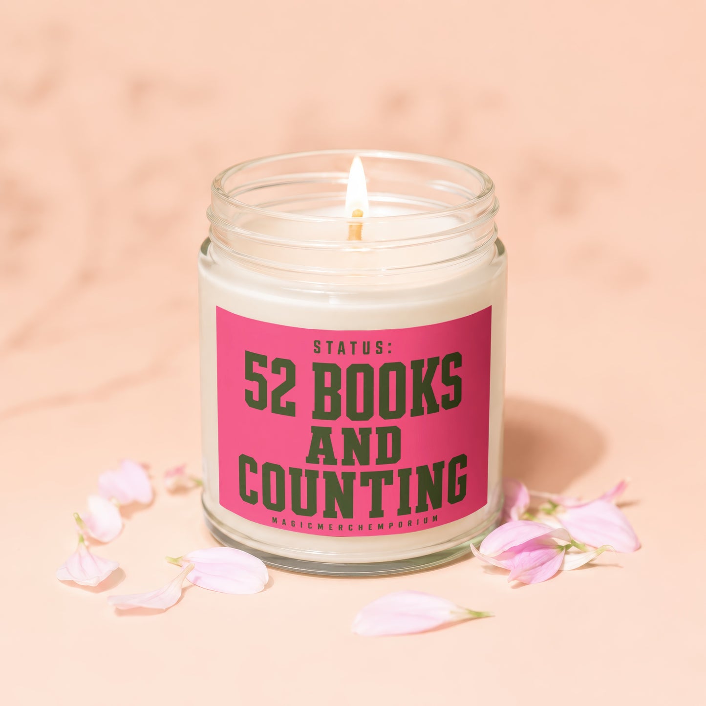Lit candle with pink label reading "Status: 52 Books and Counting".