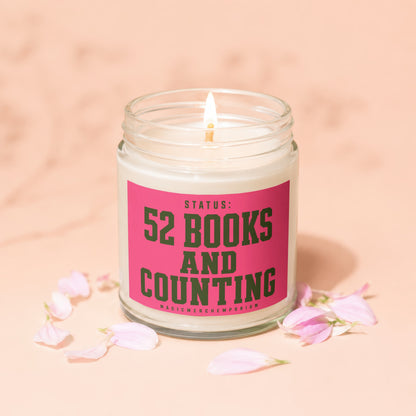 Lit candle with pink label reading "Status: 52 Books and Counting".