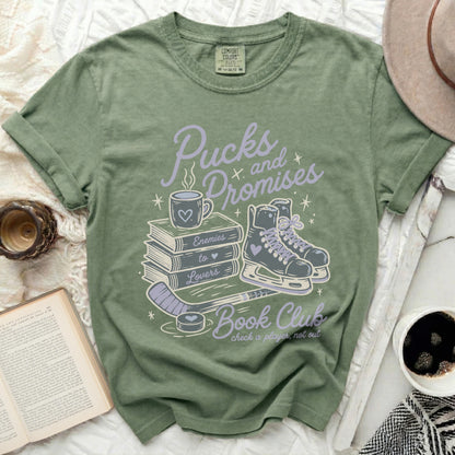 Green t-shirt with "Pucks and Promises Book Club" graphic and ice skates.