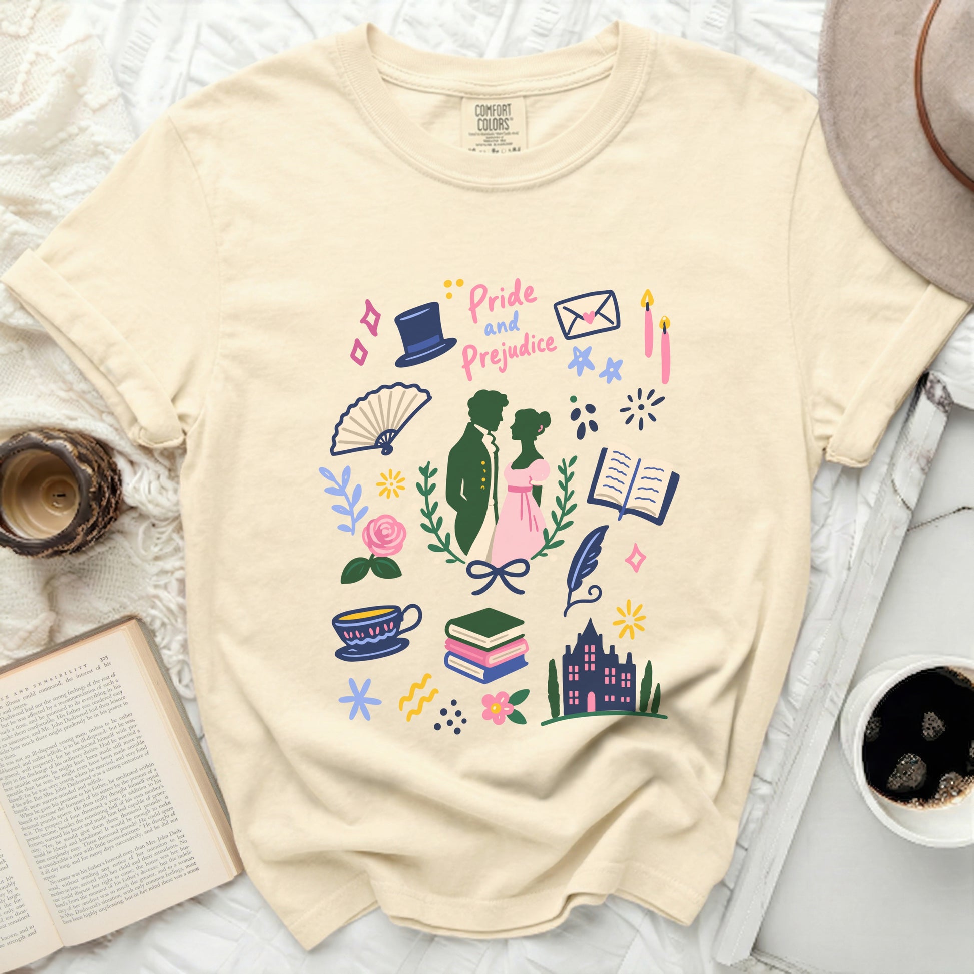 Cream t-shirt with illustrated "Pride and Prejudice" motifs and text.