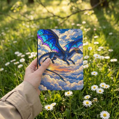 Blue dragon with stained glass wings flying through clouds at sunset.