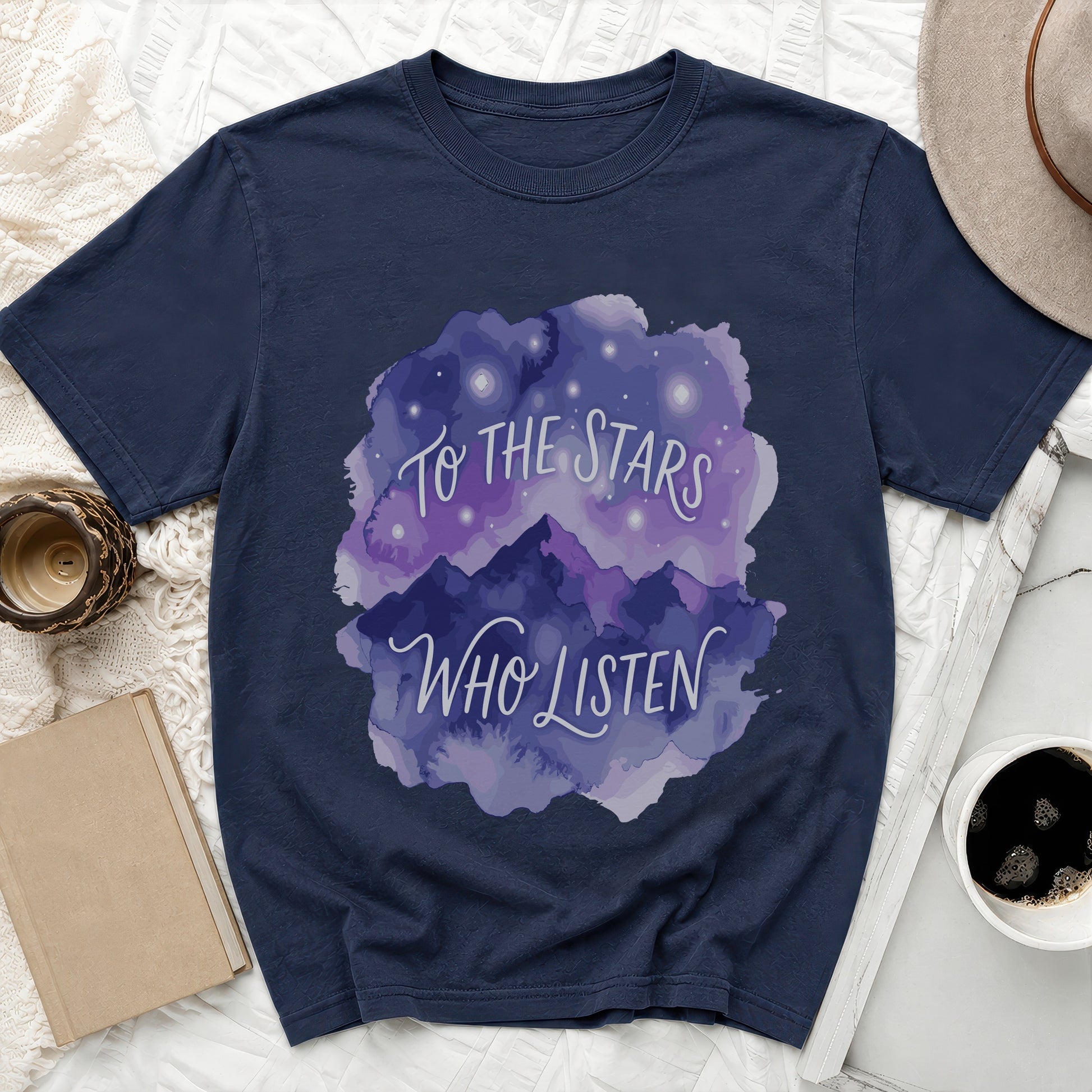 Navy t-shirt with watercolor mountains, stars, and text "To the Stars Who Listen".