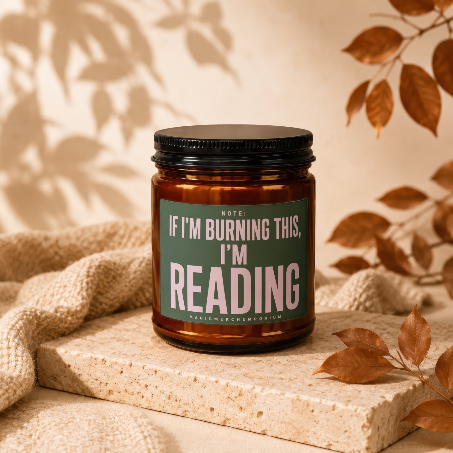Amber jar candle with green label reads "Note: If I'm Burning This, I'm Reading".