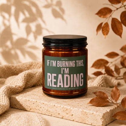 Amber jar candle with green label reads "Note: If I'm Burning This, I'm Reading".