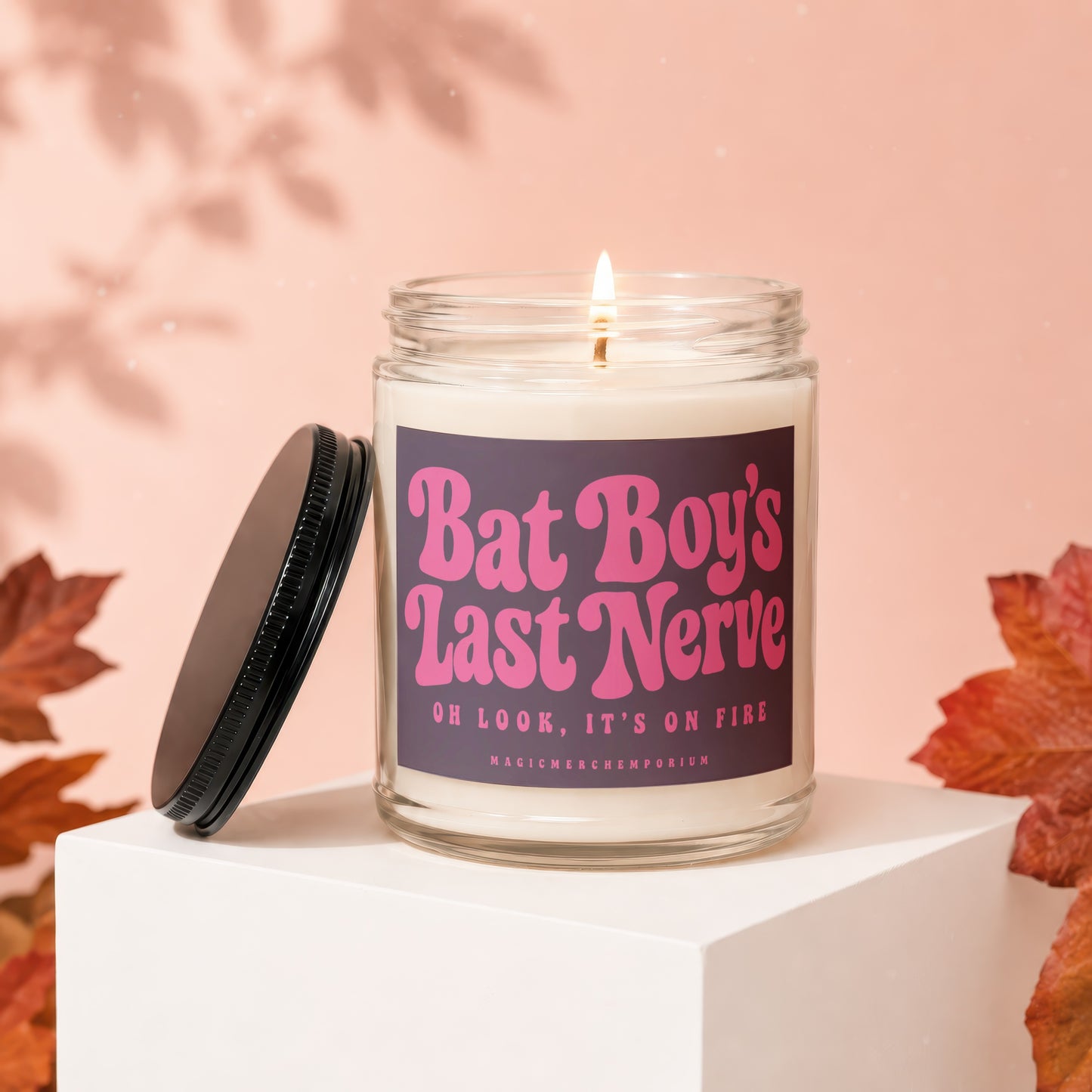 Burning candle with "Bat Boy's Last Nerve" text and "Magic Merch Emporium" on label.