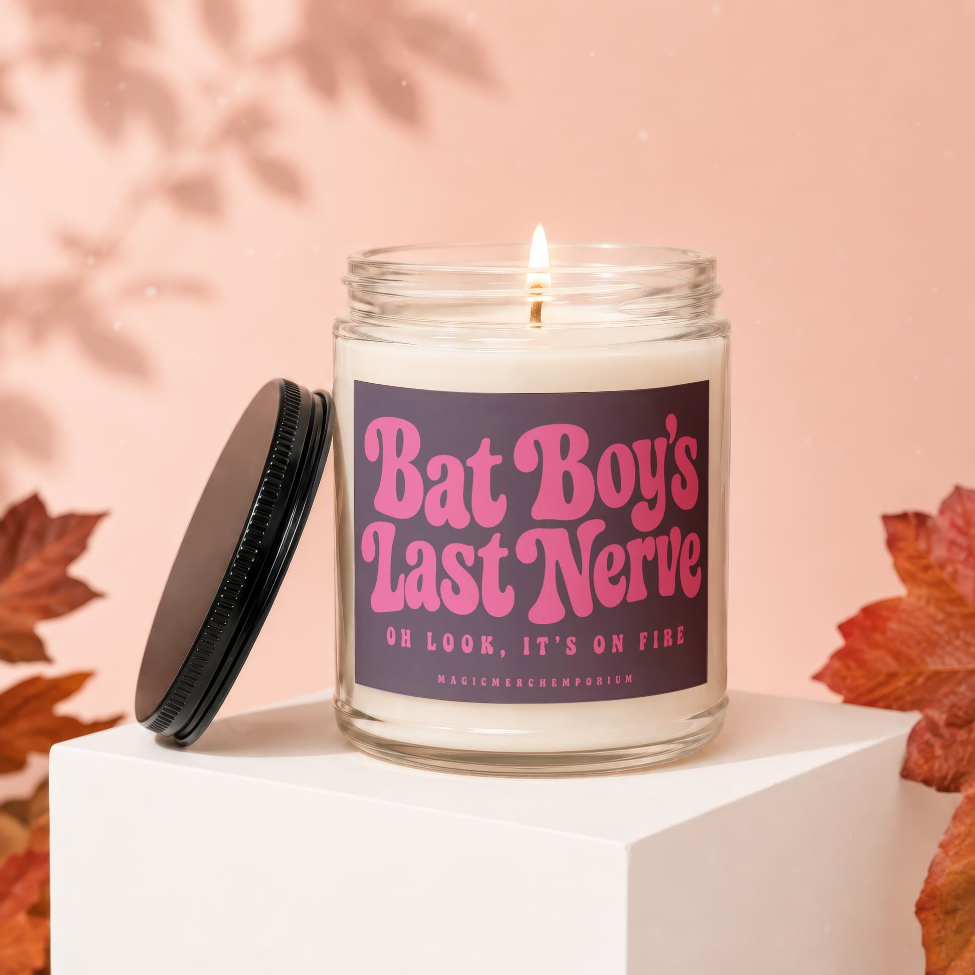 Burning candle with "Bat Boy's Last Nerve" text and "Magic Merch Emporium" on label.
