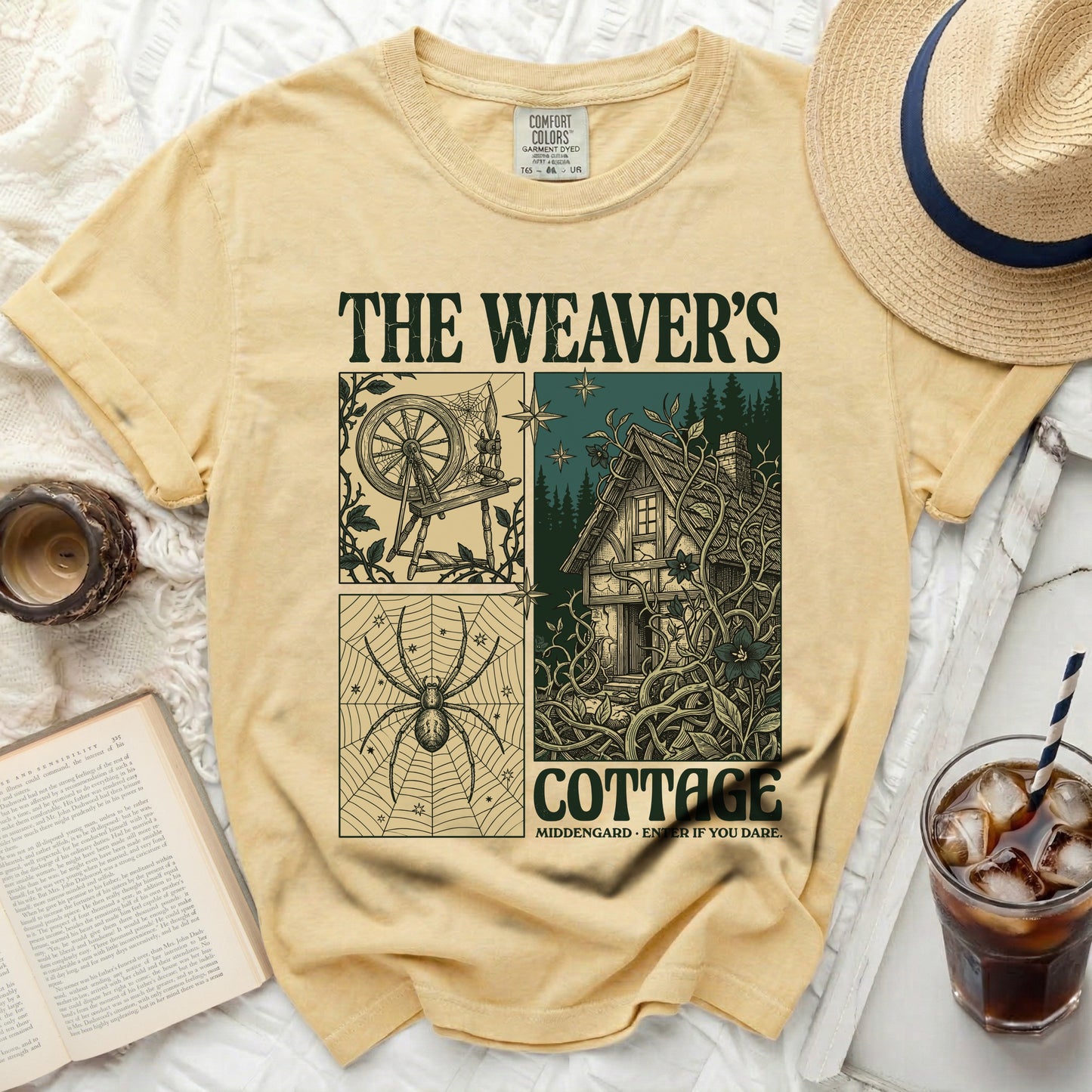 The Weaver's Cottage shirt with spinning wheel, spider, and cottage graphic.
