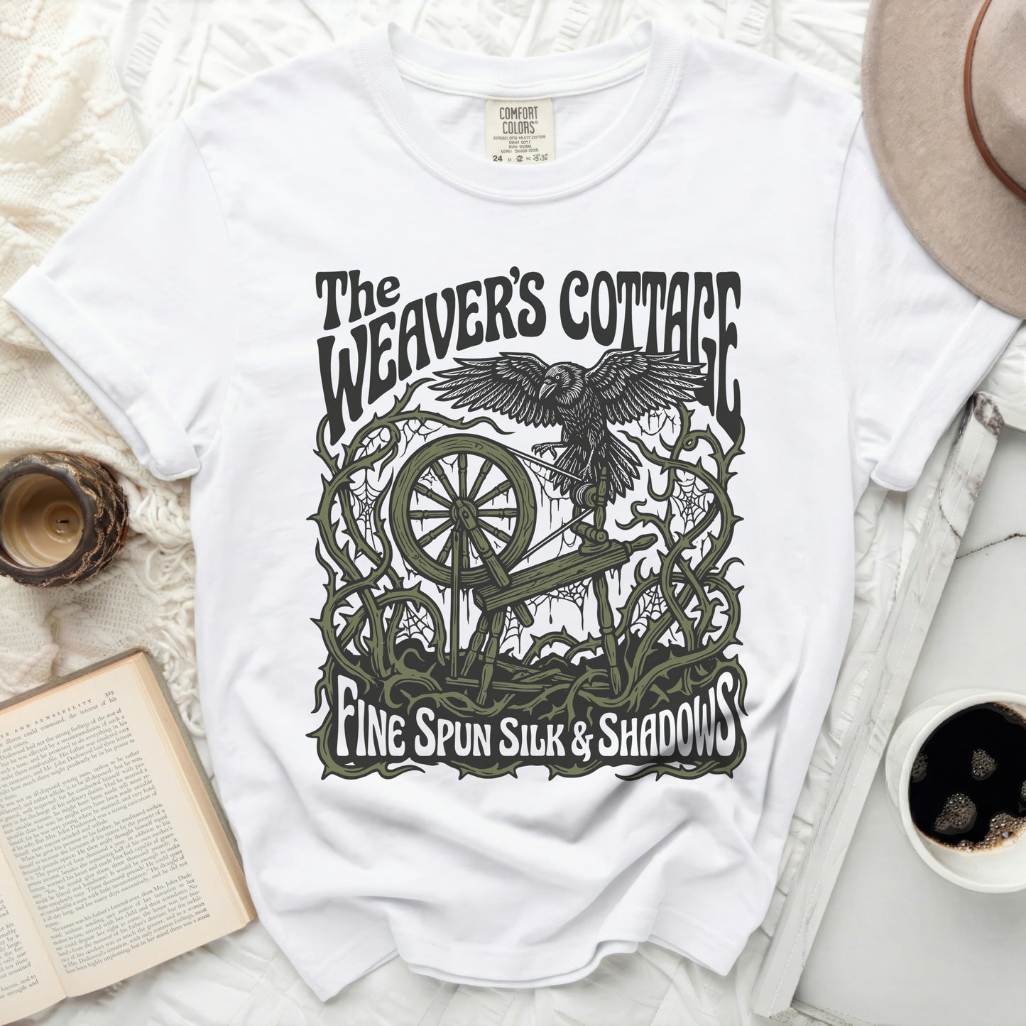 White t-shirt with "The Weaver's Cottage Fine Spun Silk & Shadows" graphic.