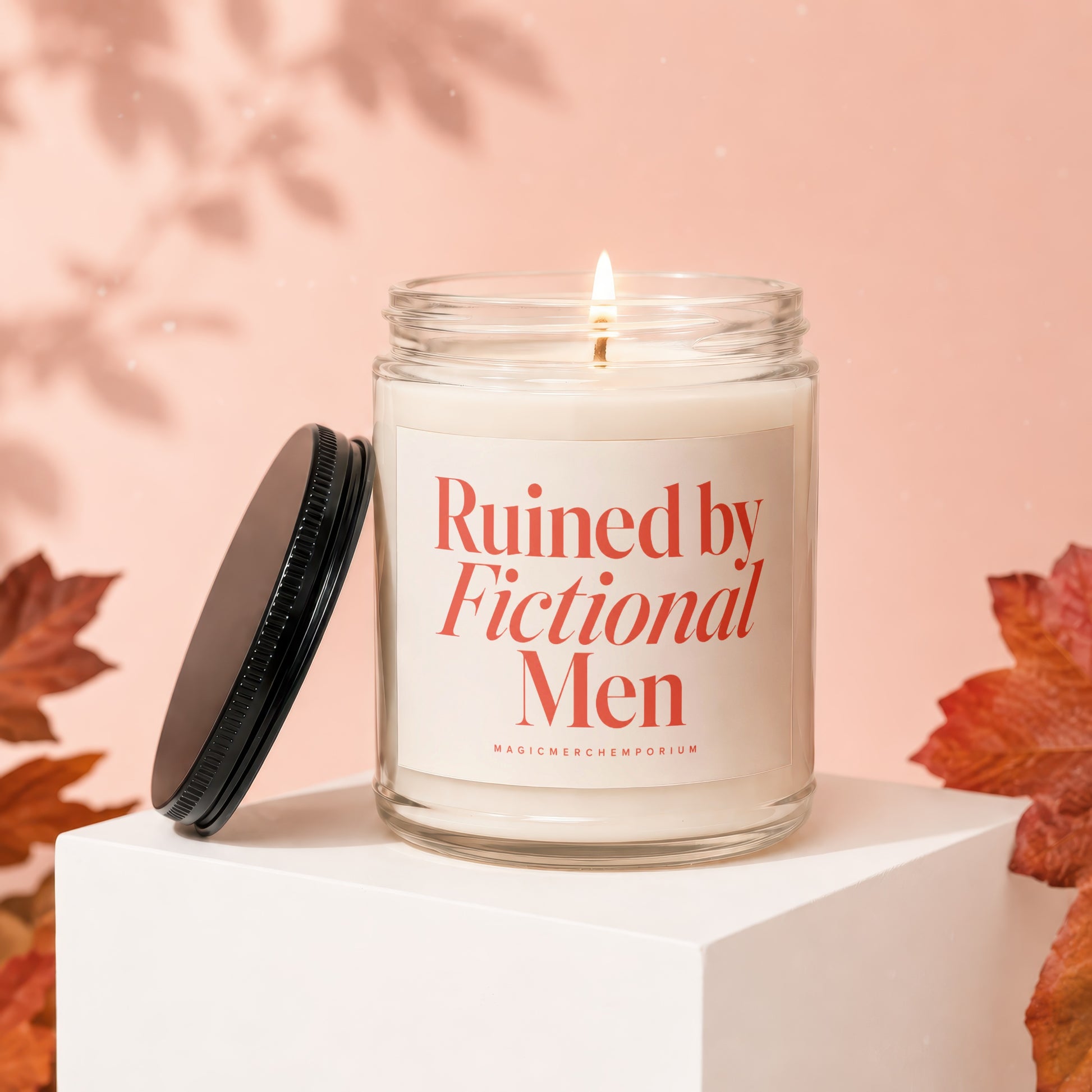 Candle with "Ruined by Fictional Men" text on label, lid beside it.