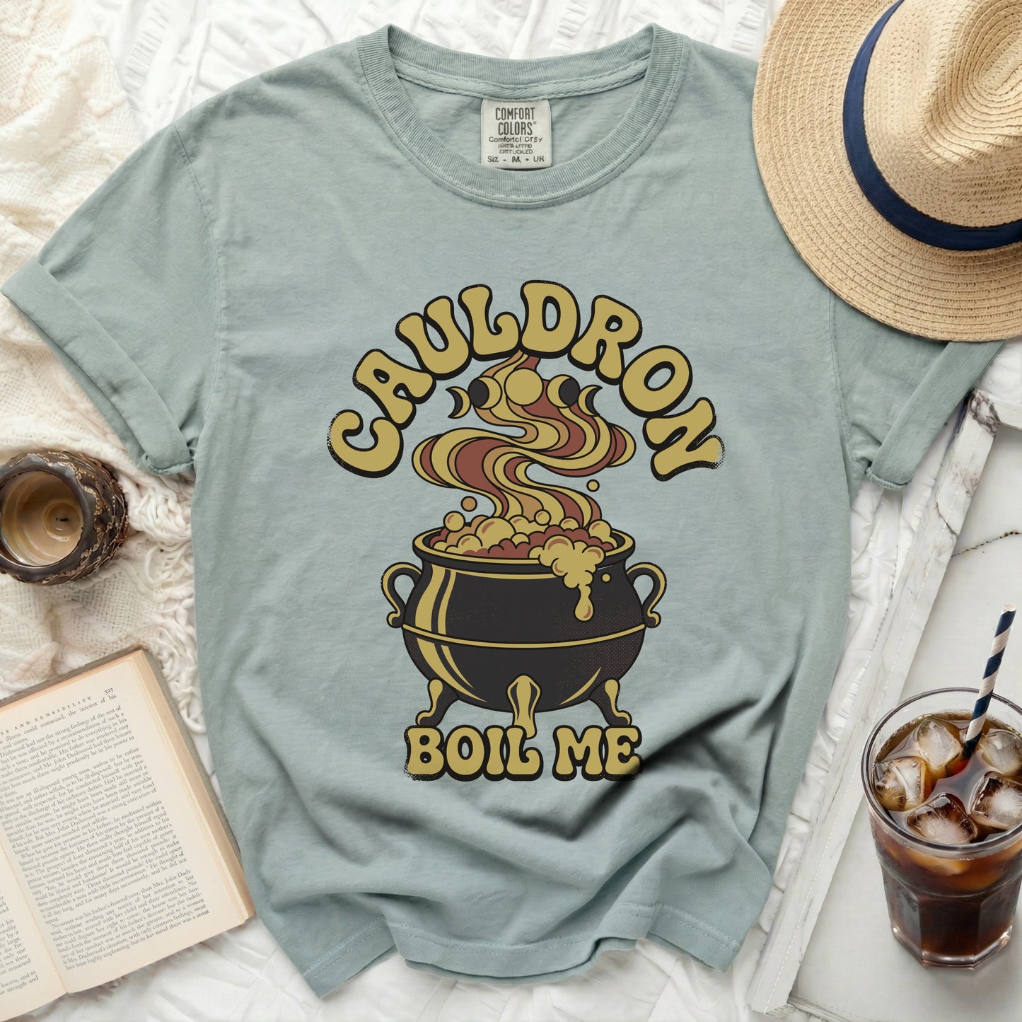 Green t-shirt with a cauldron graphic and text "CAULDRON BOIL ME".