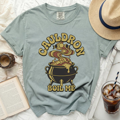 Green t-shirt with a cauldron graphic and text "CAULDRON BOIL ME".