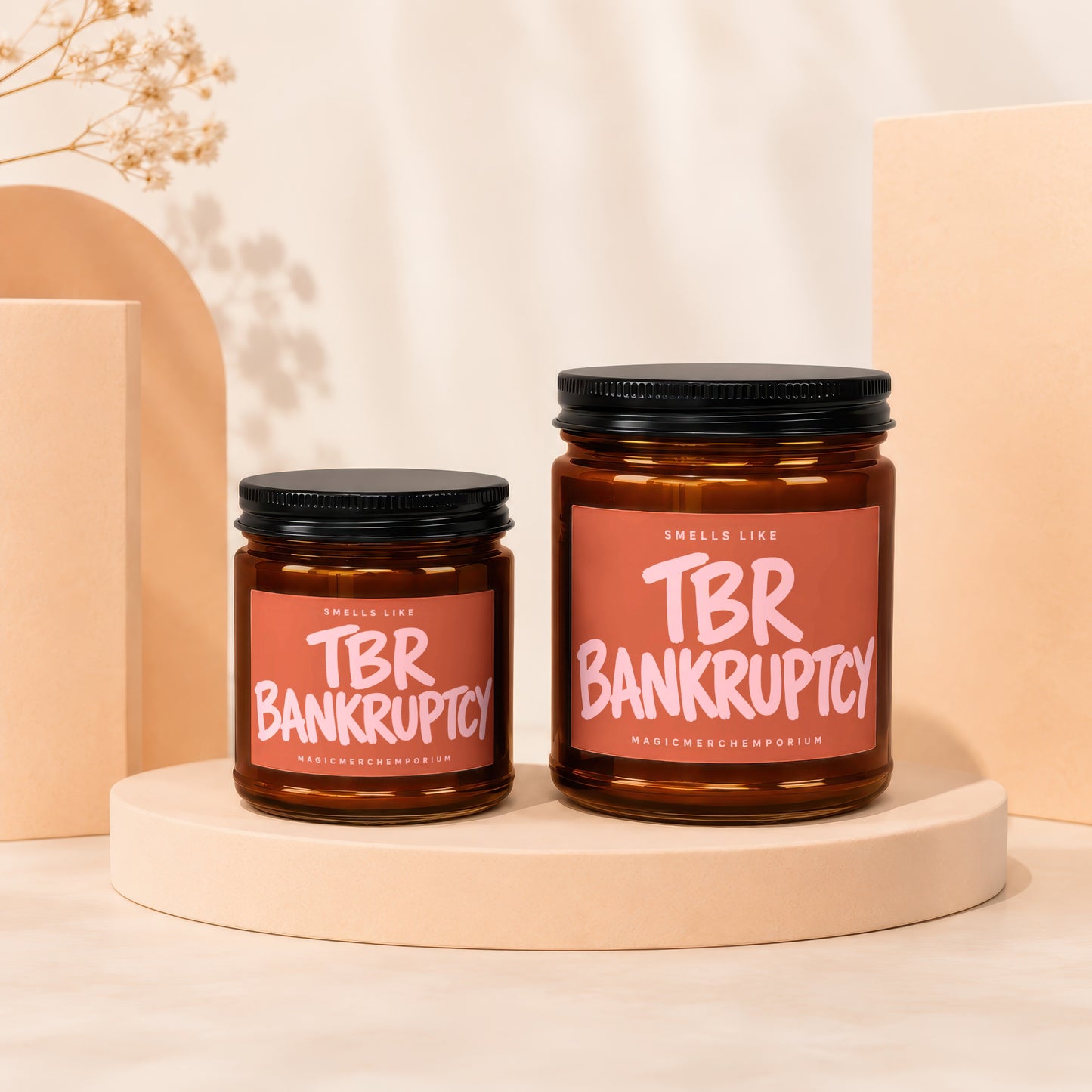 Two amber glass jars with black lids, labeled "Smells Like TBR Bankruptcy".