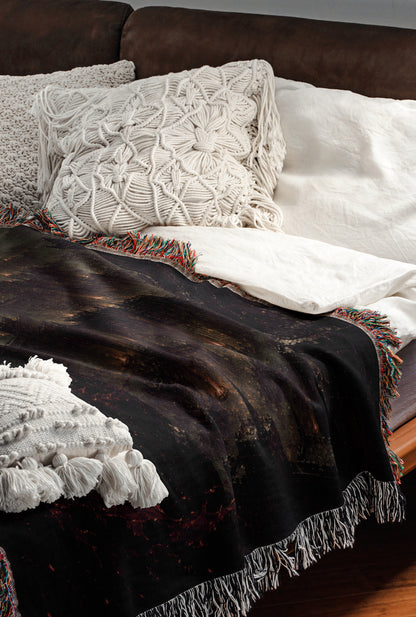 a cozy and inviting bedroom scene, featuring a bed with a black blanket and white pillows, a brown leather couch, and a colorful throw blanket.