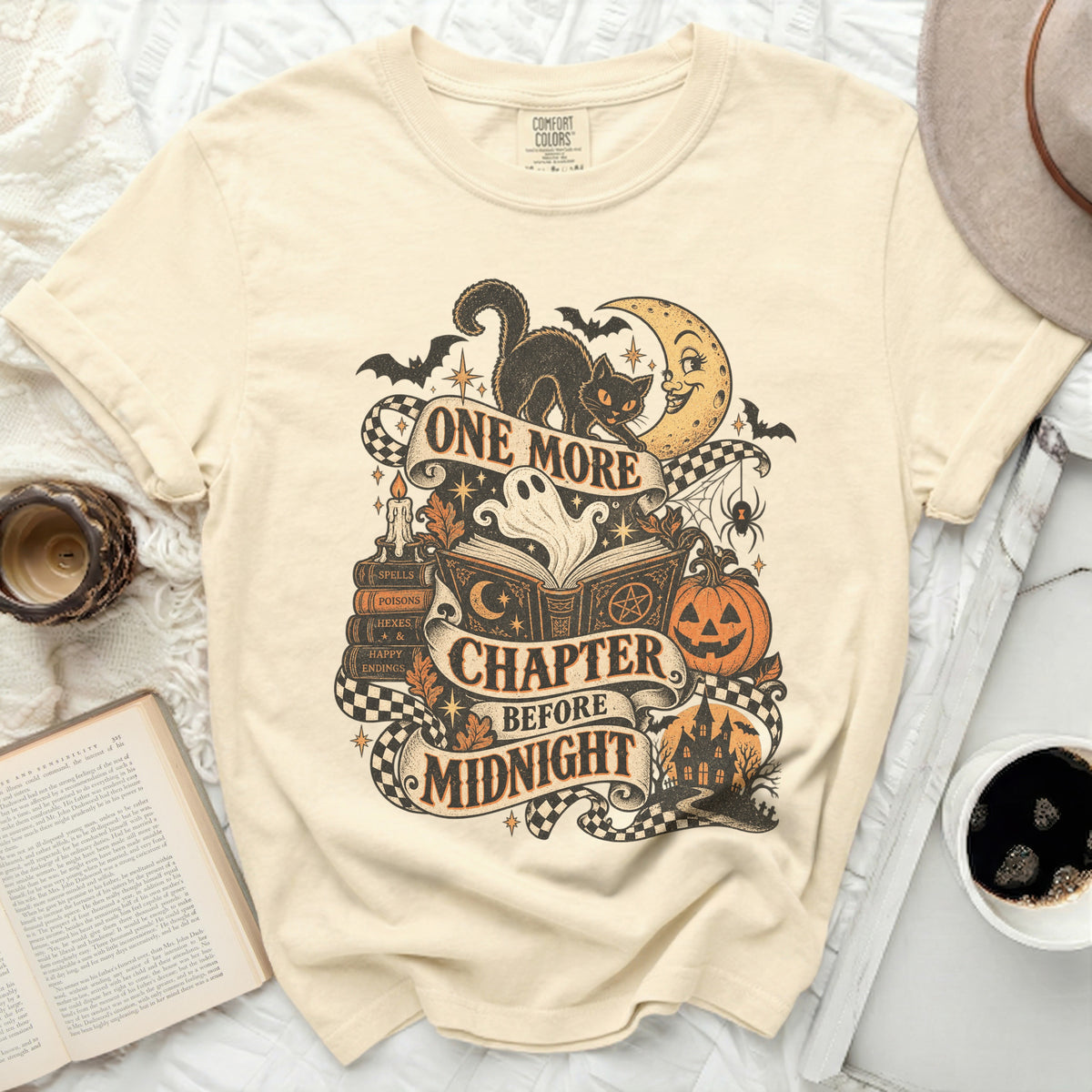 T-shirt with vintage Halloween design featuring a black cat and text "One More Chapter Before Midnight."