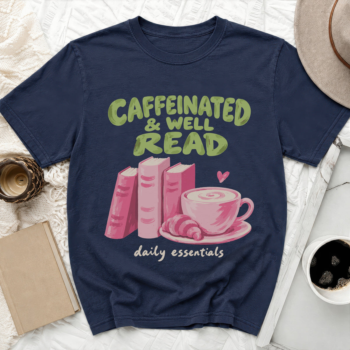 Navy t-shirt with "Caffeinated & Well Read" and "daily essentials" text and book graphics.