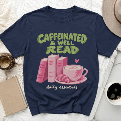 Navy t-shirt with "Caffeinated & Well Read" and "daily essentials" text and book graphics.