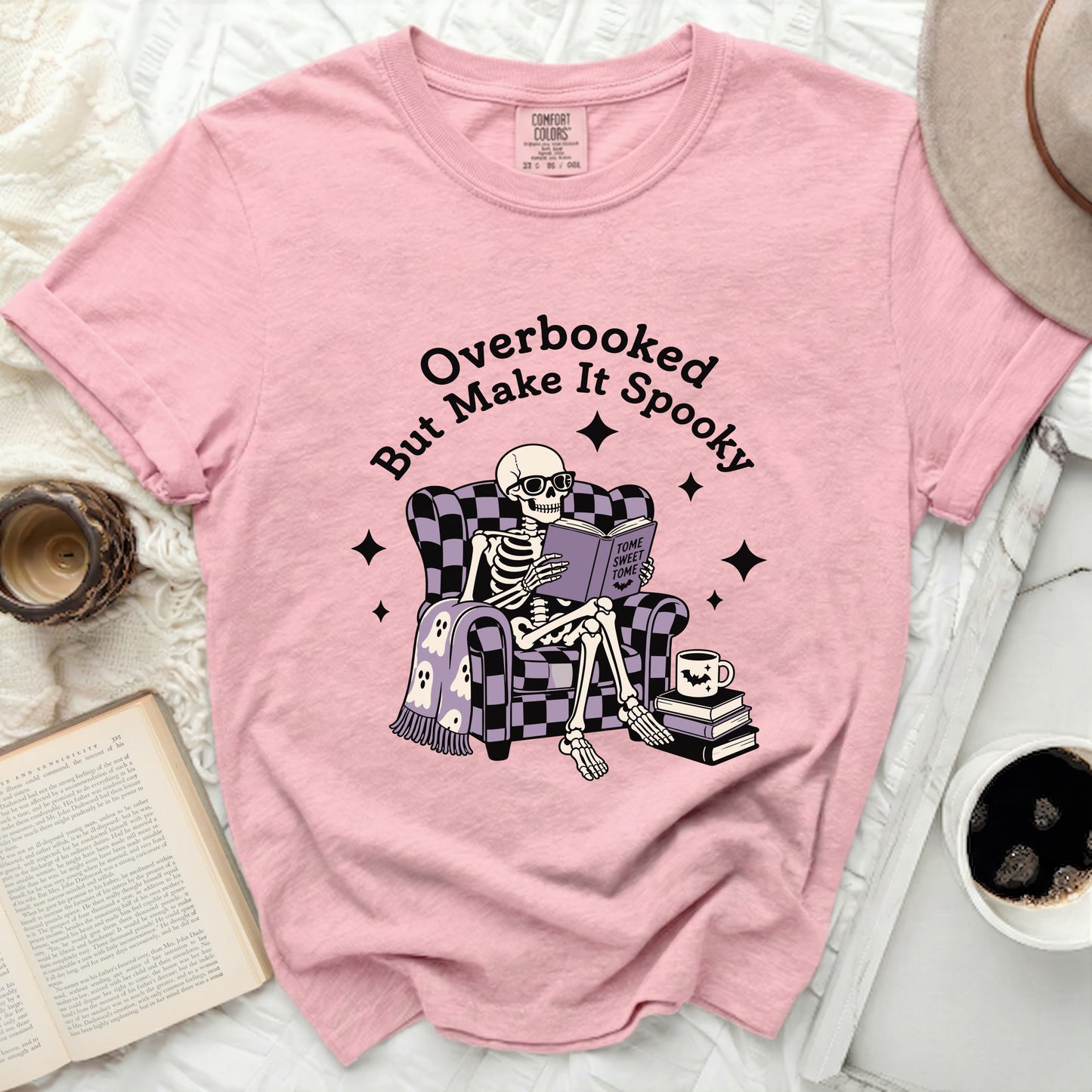 Skeleton reading "Tome Sweet Tome" on pink Comfort Colors shirt