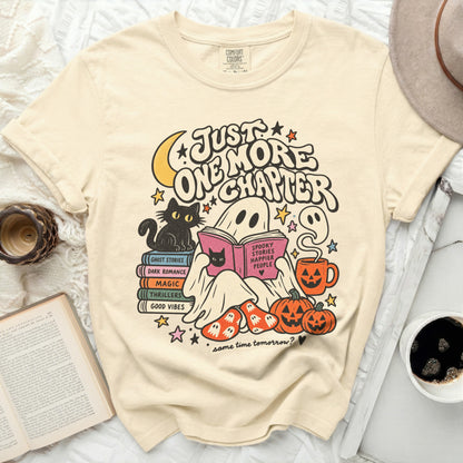 T-shirt with ghost reading "Spooky Stories Happier People" and "Just One More Chapter" text.