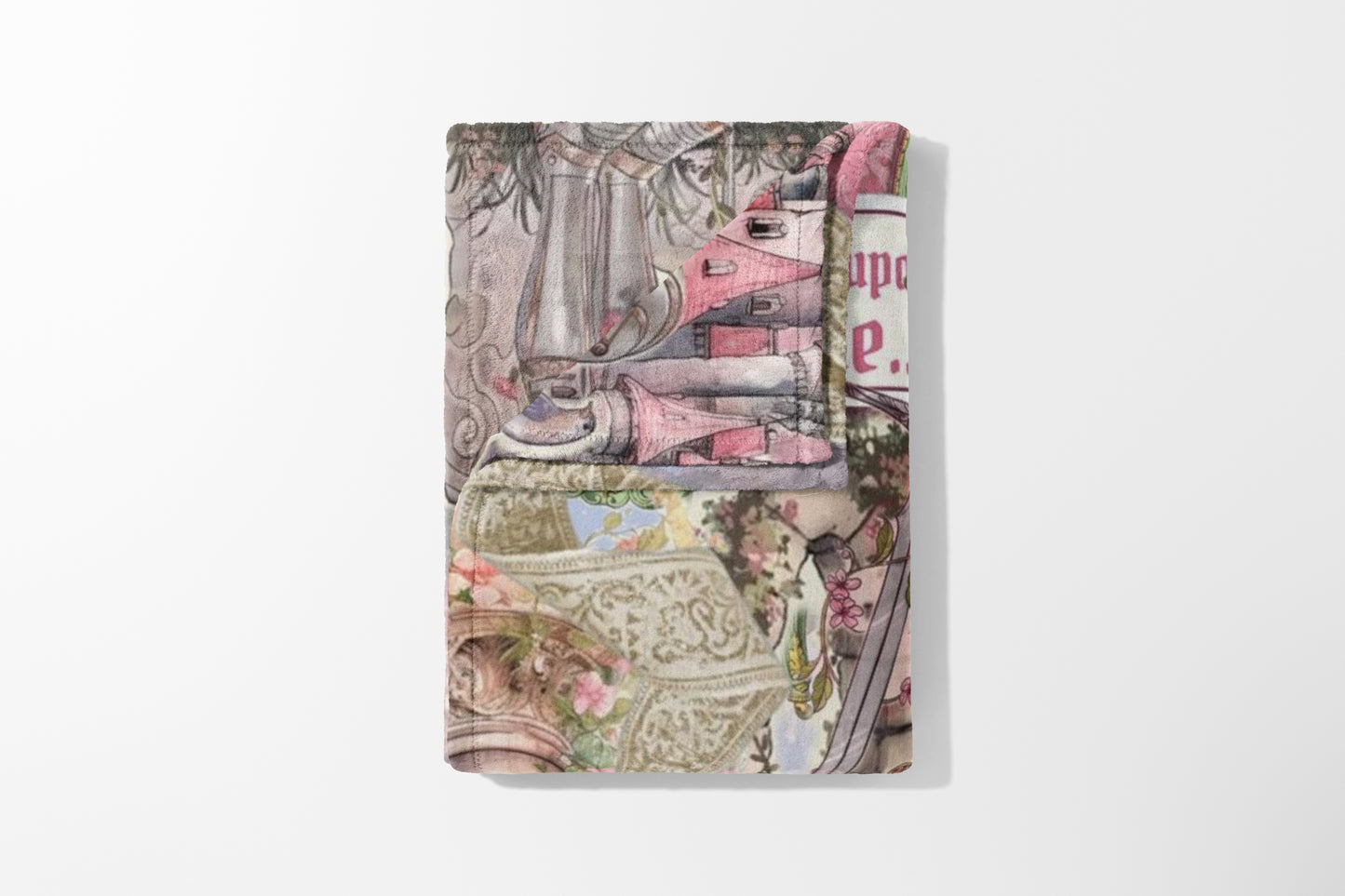 Folded blanket with a pink, gray, and tan toile-style print featuring houses and floral elements.