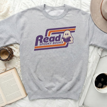 Grey sweatshirt with "Read Spooky Books" retro ghost graphic.