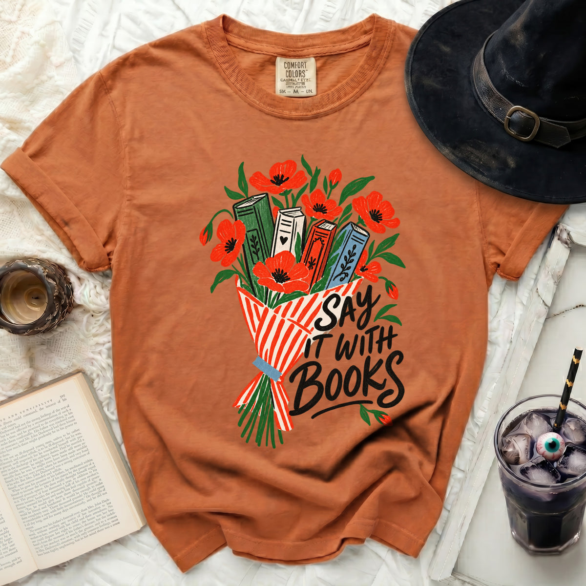 Orange t-shirt with "Say it with Books" graphic and book bouquet.