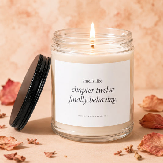 Candle with text "smells like chapter twelve finally behaving." and logo.