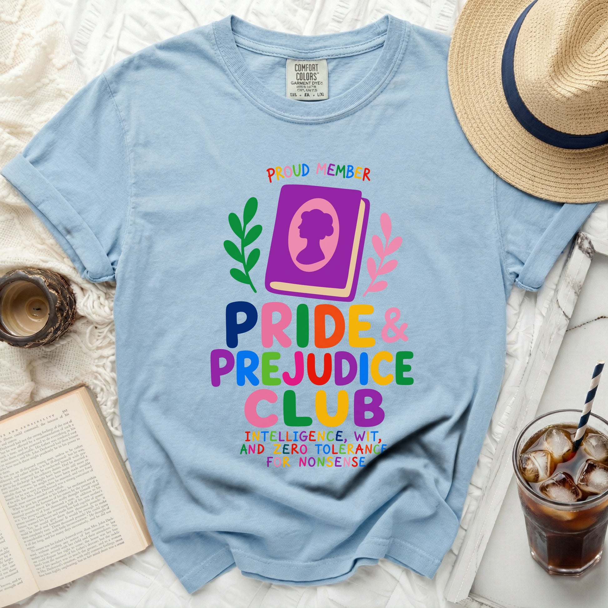 Light blue Comfort Colors t-shirt with Pride & Prejudice Club graphic and distressed book details.