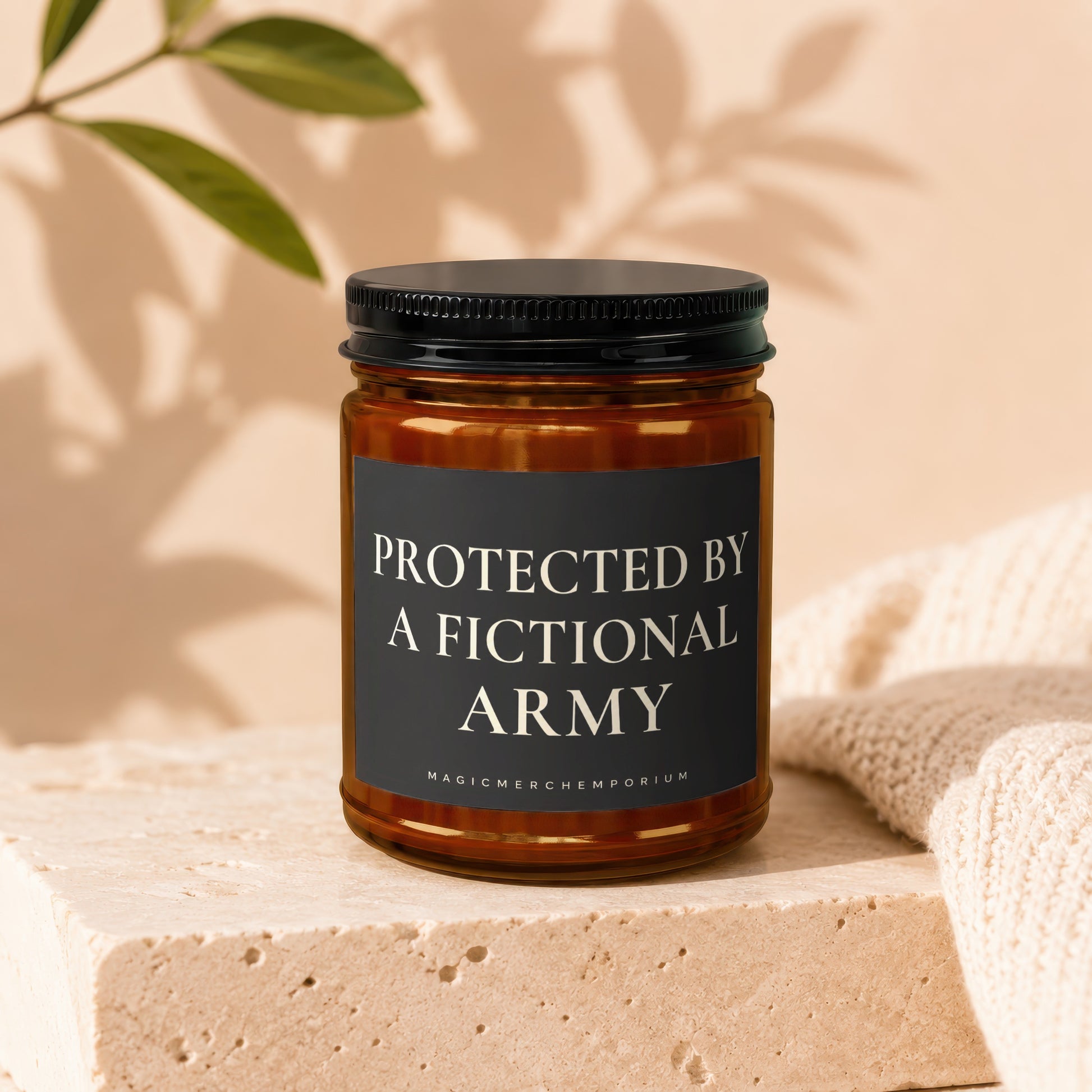 Amber jar candle with black lid reading "Protected by a Fictional Army."