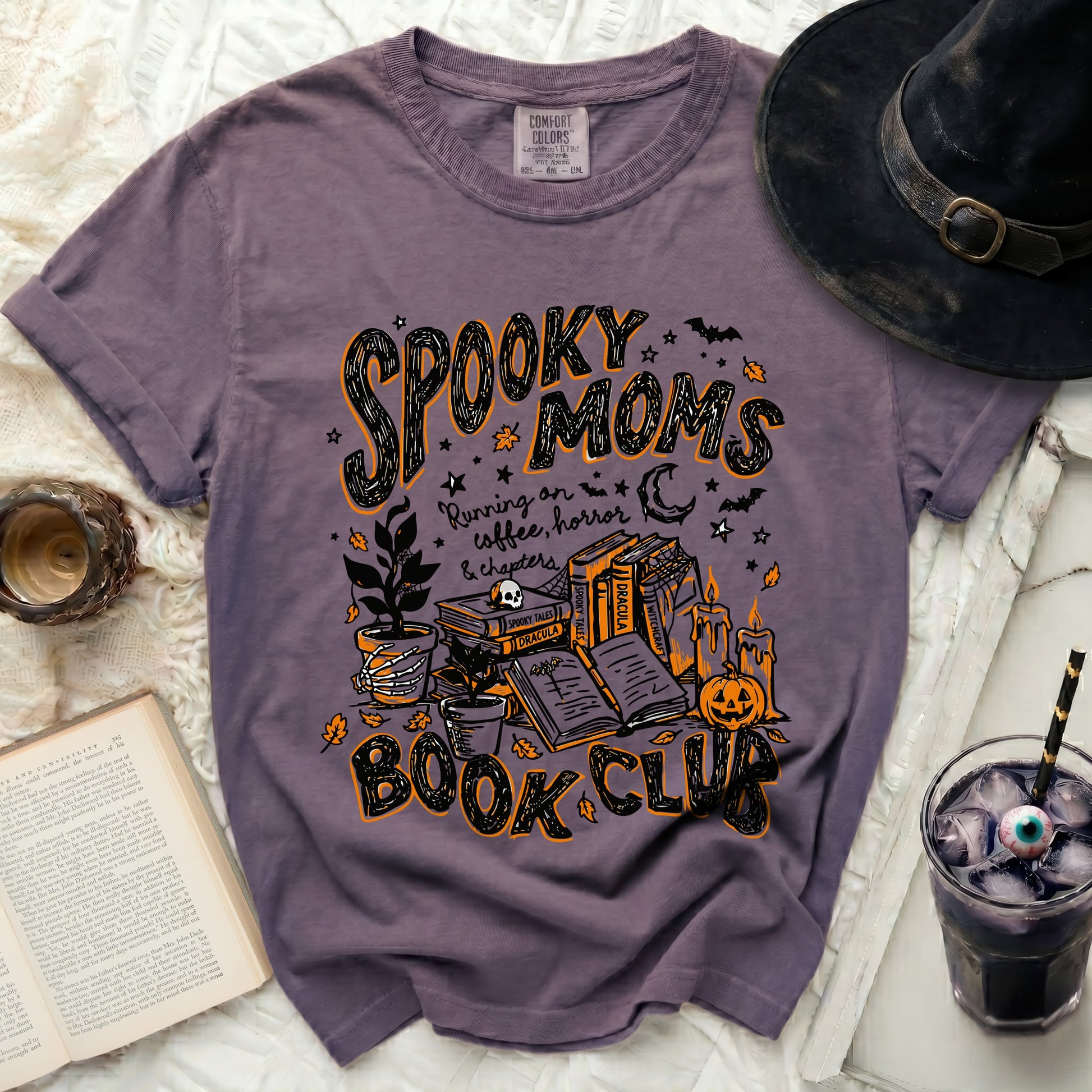 Purple t-shirt with "Spooky Moms Book Club" Halloween graphic design.