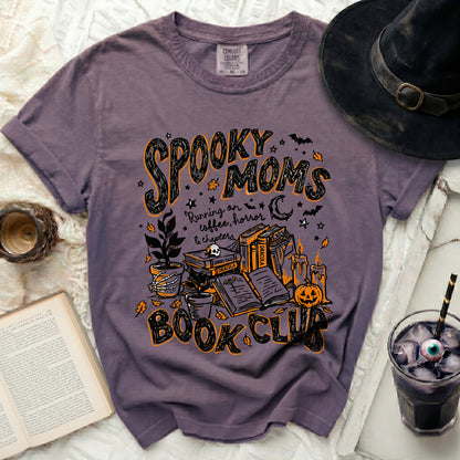 Purple t-shirt with "Spooky Moms Book Club" Halloween graphic design.