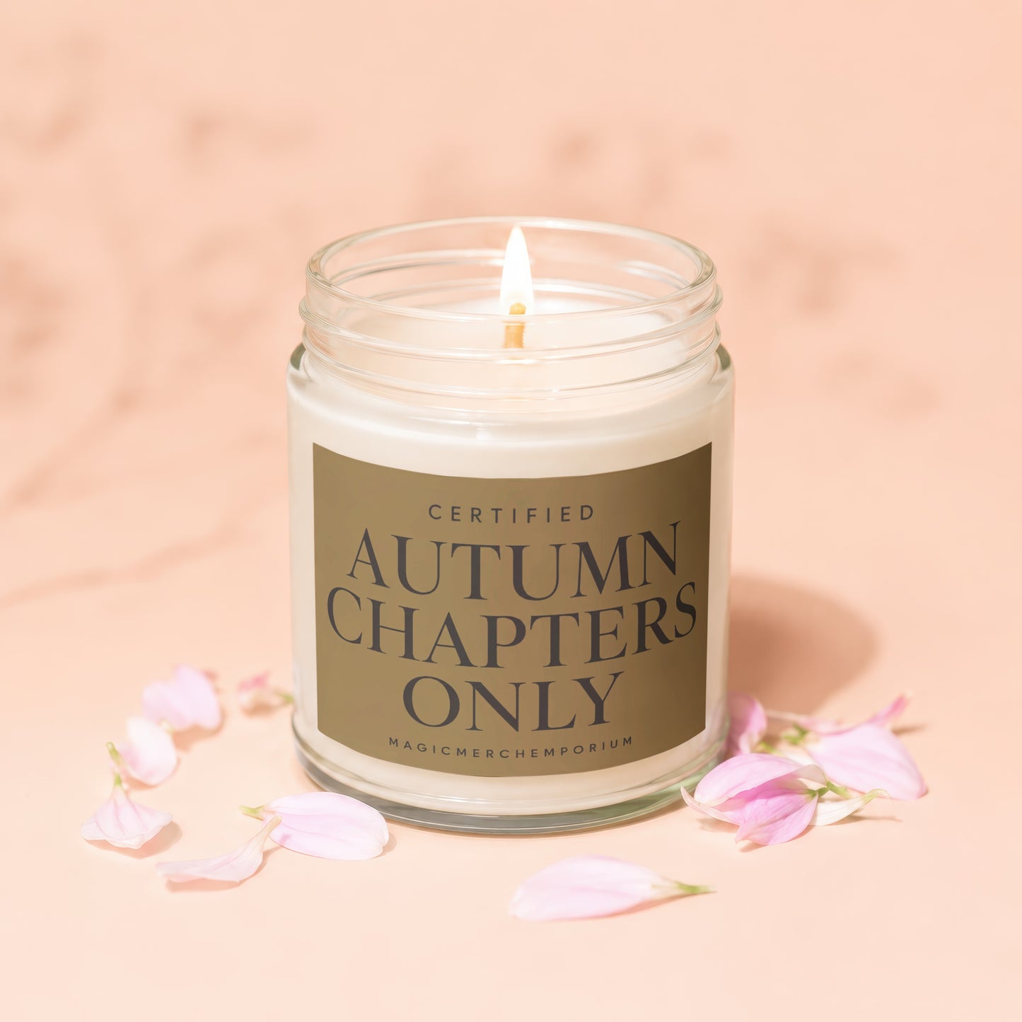 Glass jar candle labeled "Certified Autumn Chapters Only".