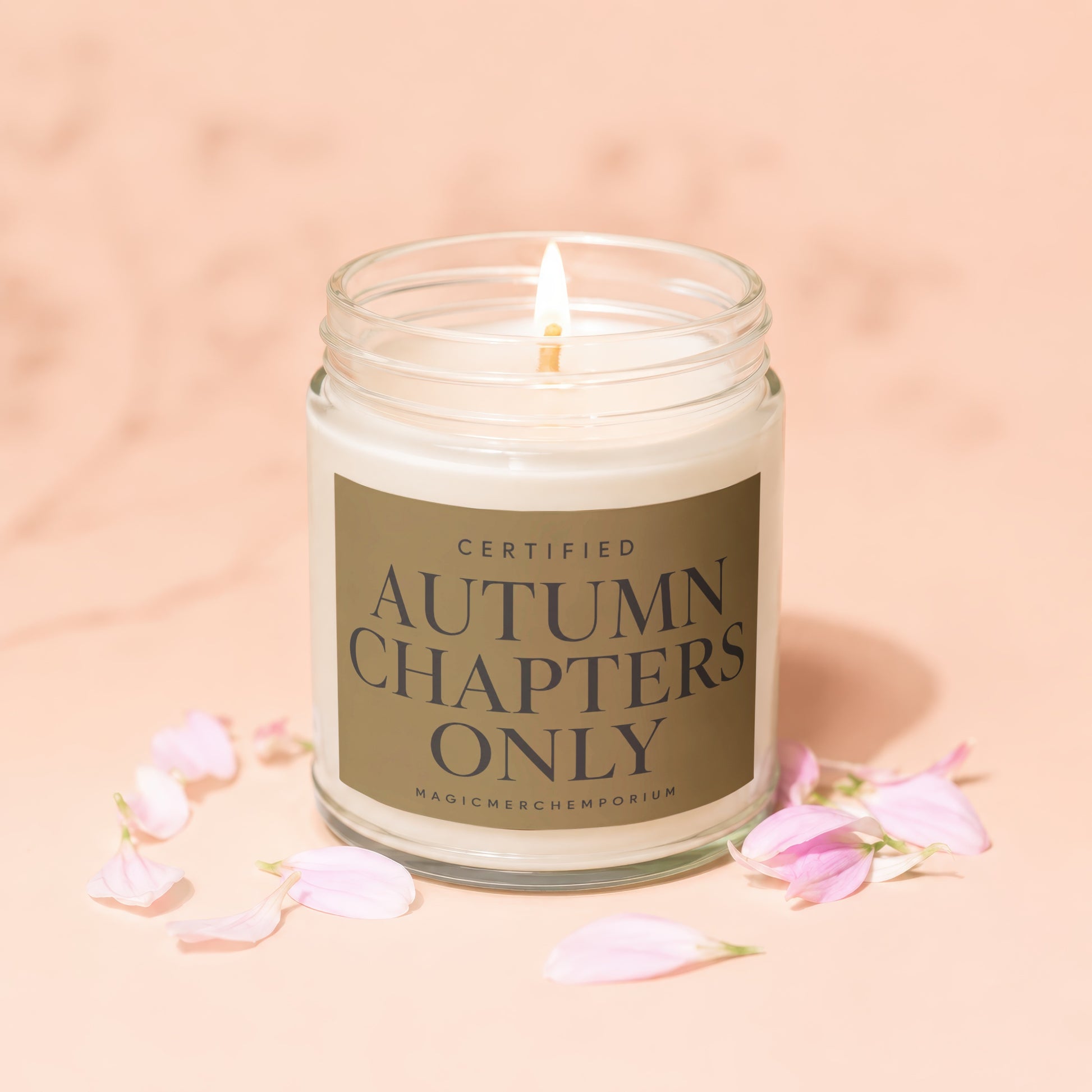 Glass jar candle labeled "Certified Autumn Chapters Only".