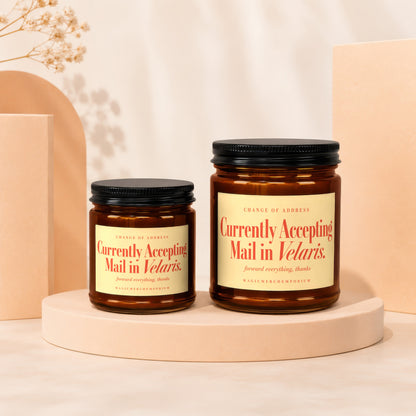 Two amber apothecary jars with black lids, labeled "Currently Accepting Mail in Velaris."