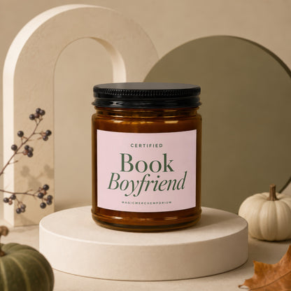 Amber glass candle with "CERTIFIED Book Boyfriend" label on pink background.