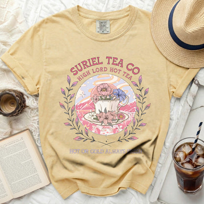 Yellow t-shirt with a floral teacup design and "Suriel Tea Co" text.