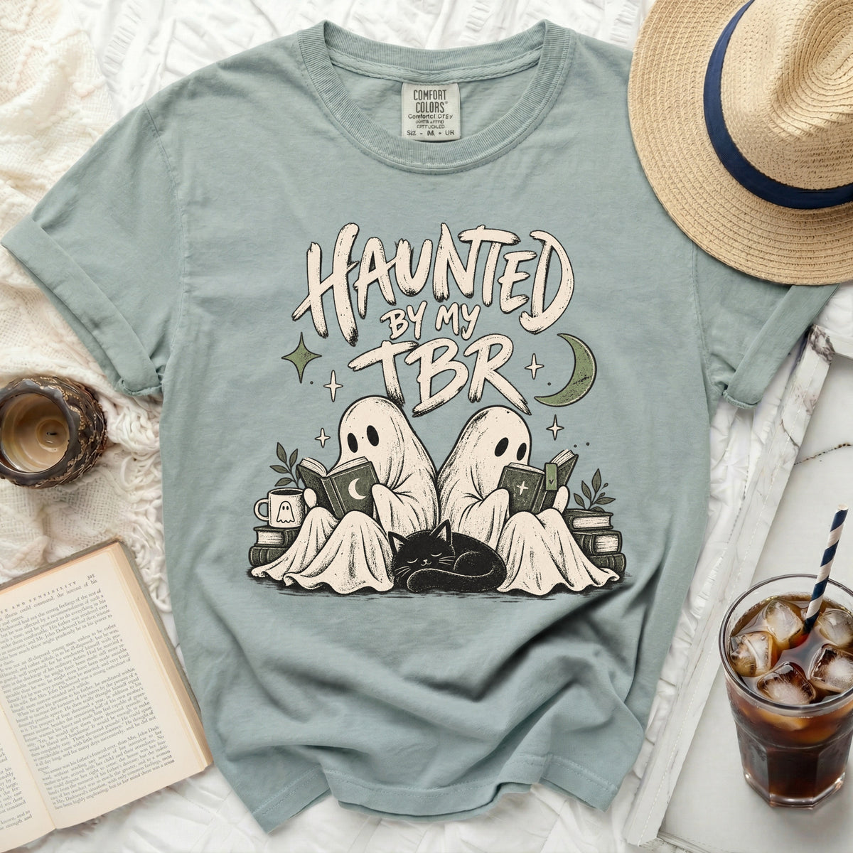 Two ghosts read books with a cat, "Haunted by my TBR" text.