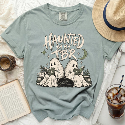 Two ghosts read books with a cat, "Haunted by my TBR" text.