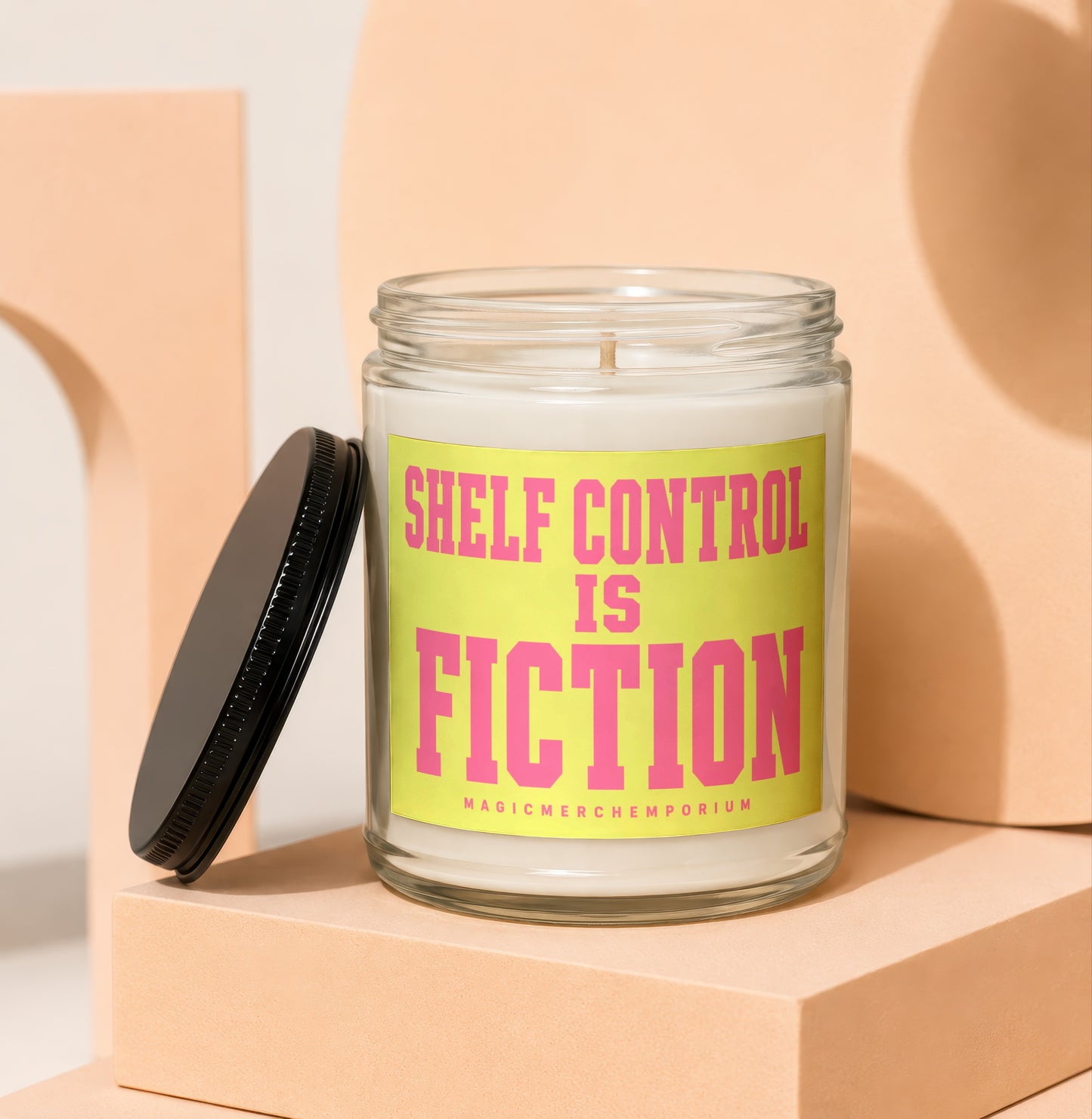 Glass jar candle with "Shelf Control Is Fiction" text on a yellow label.