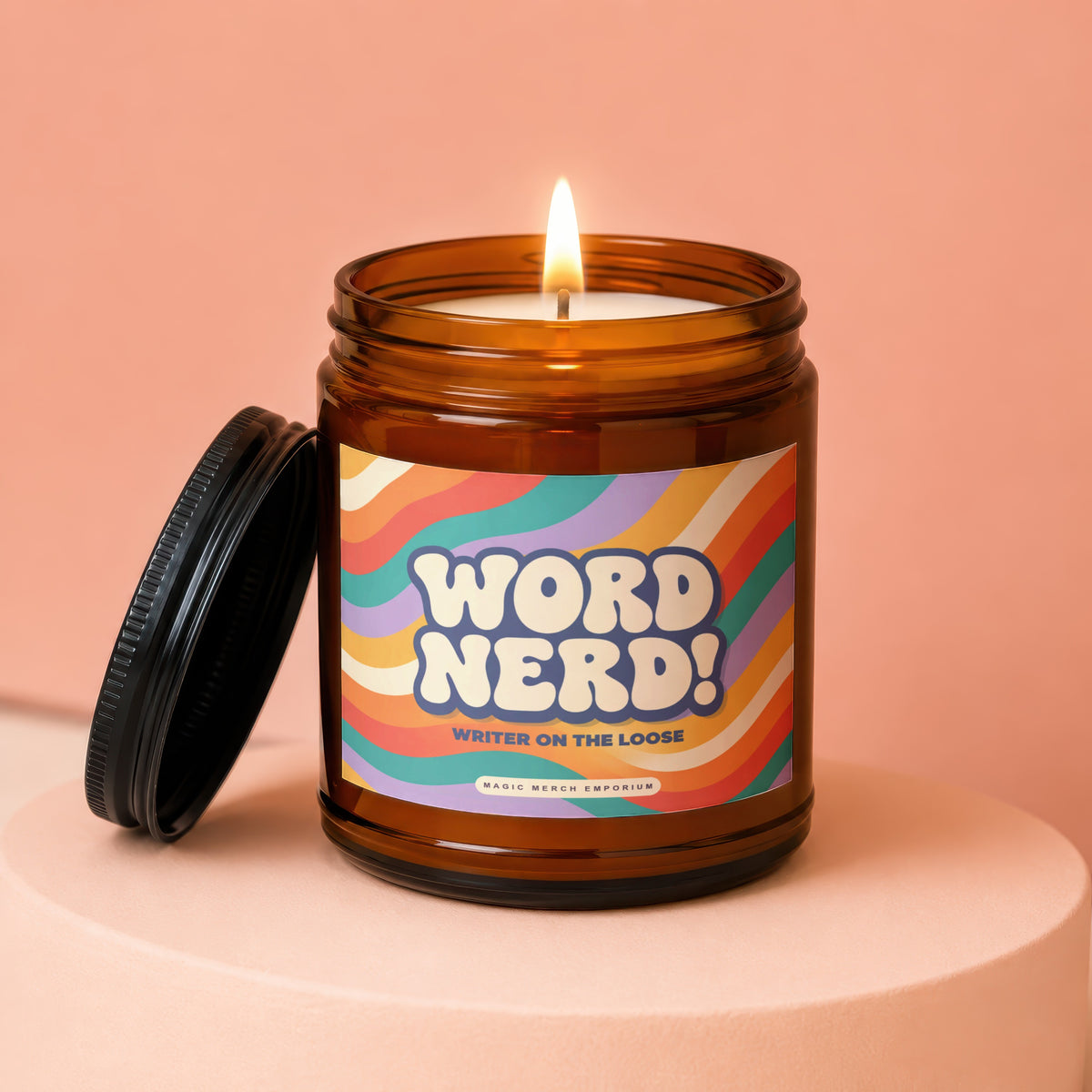 Amber candle with lit wick and "Word Nerd! Writer on the Loose" label.