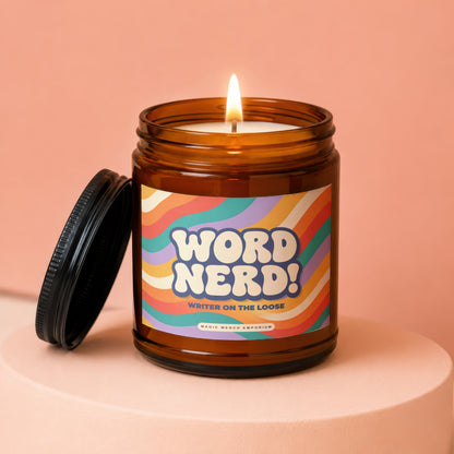 Amber candle with lit wick and "Word Nerd! Writer on the Loose" label.